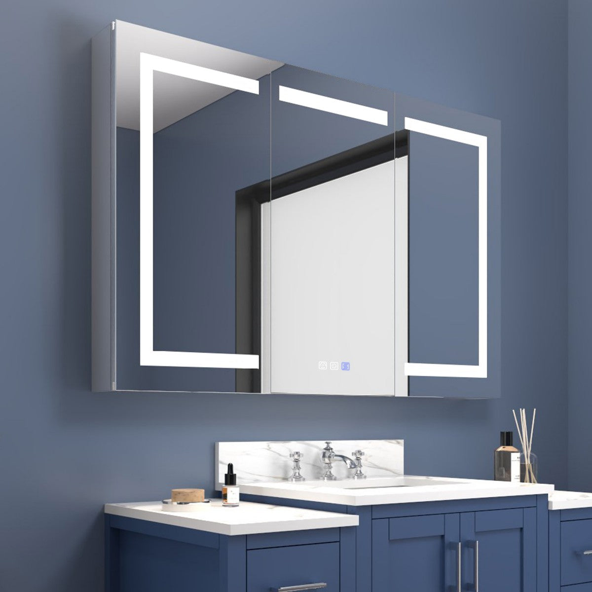Bathroom vanity with illuminated mirror against a blue wall