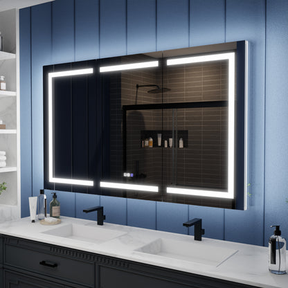 Bathroom vanity with a large illuminated mirror against a blue paneled wall.