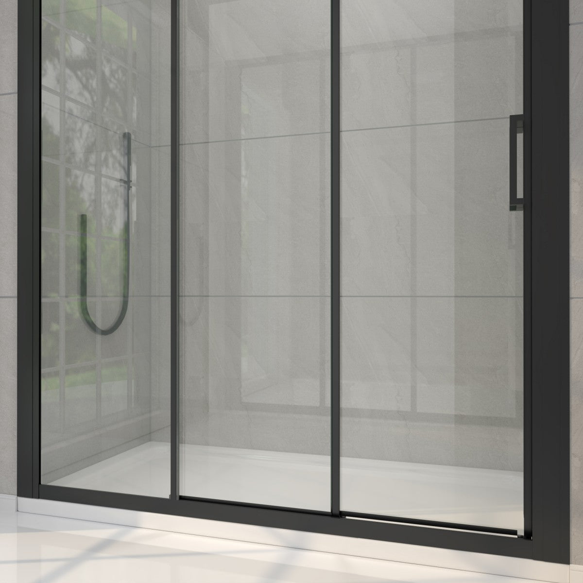 Modern shower enclosure with glass door and black frame in a tiled bathroom.
