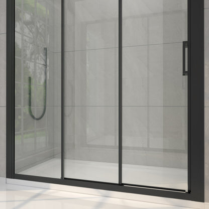 Modern shower enclosure with glass door and black frame in a tiled bathroom.
