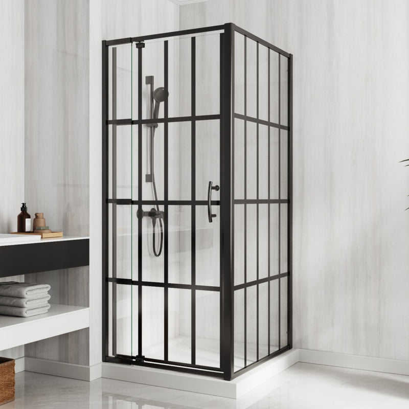 Corner shower enclosure with black metal frame and glass panels in a bathroom setting.