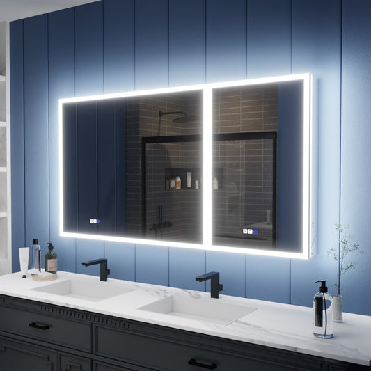A large rectangular LED-backlit bathroom mirror mounted on a blue paneled wall above a double-sink vanity with black faucets and white marble countertops.