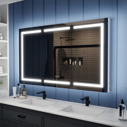 Bathroom vanity with a large illuminated mirror against a blue paneled wall.