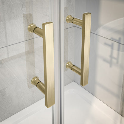 Gold shower door handles on a glass shower enclosure