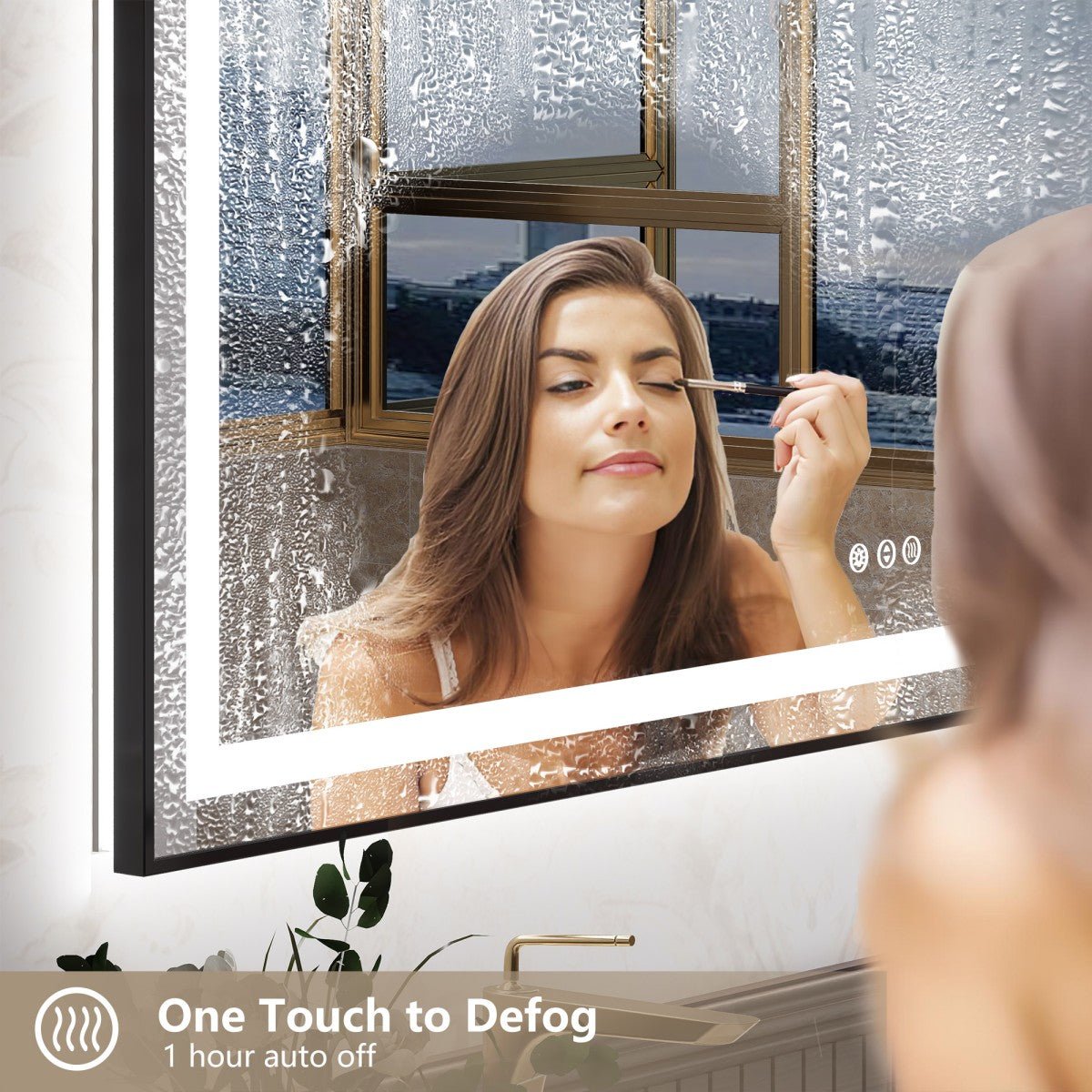 A smart bathroom mirror with a black frame and built-in LED lighting, shown fogged up. A woman is visible in the mirror applying makeup, with her reflection also shown in the foreground.