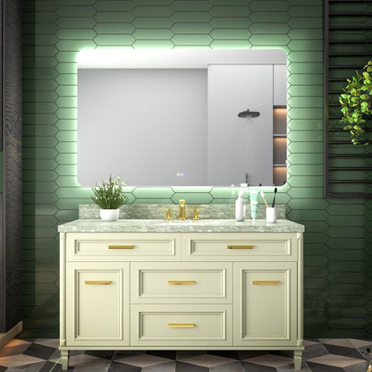 Bathroom vanity with illuminated mirror against a green tiled wall.