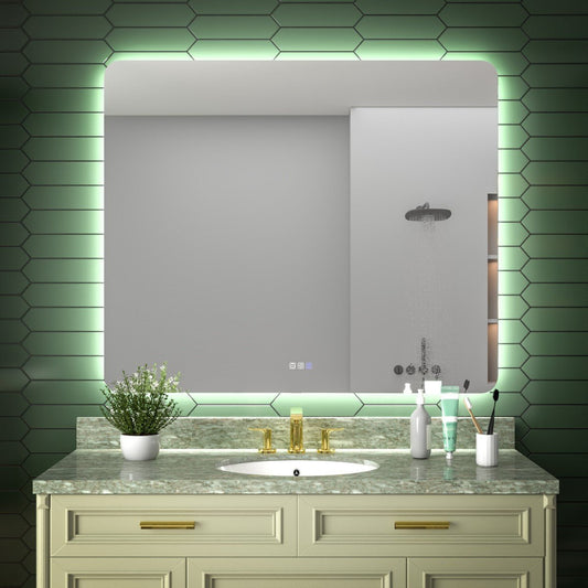 Bathroom vanity with sink, mirror, and decorative elements against a green tiled wall.